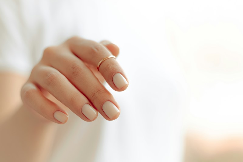 Hand with a clean white manicure
